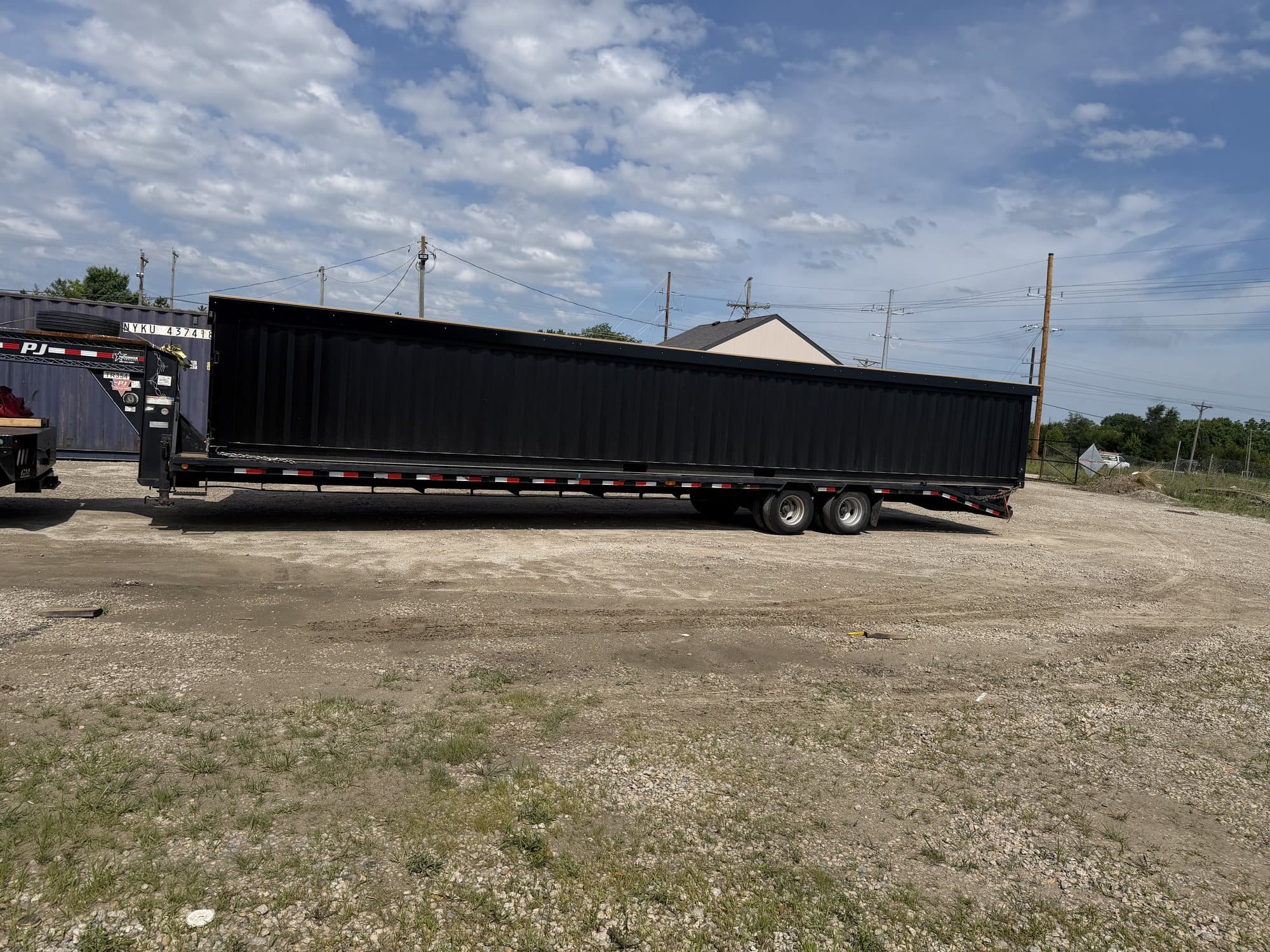 A 40ft container pool strapped to a flatbed trailer at the Leavenworth shop